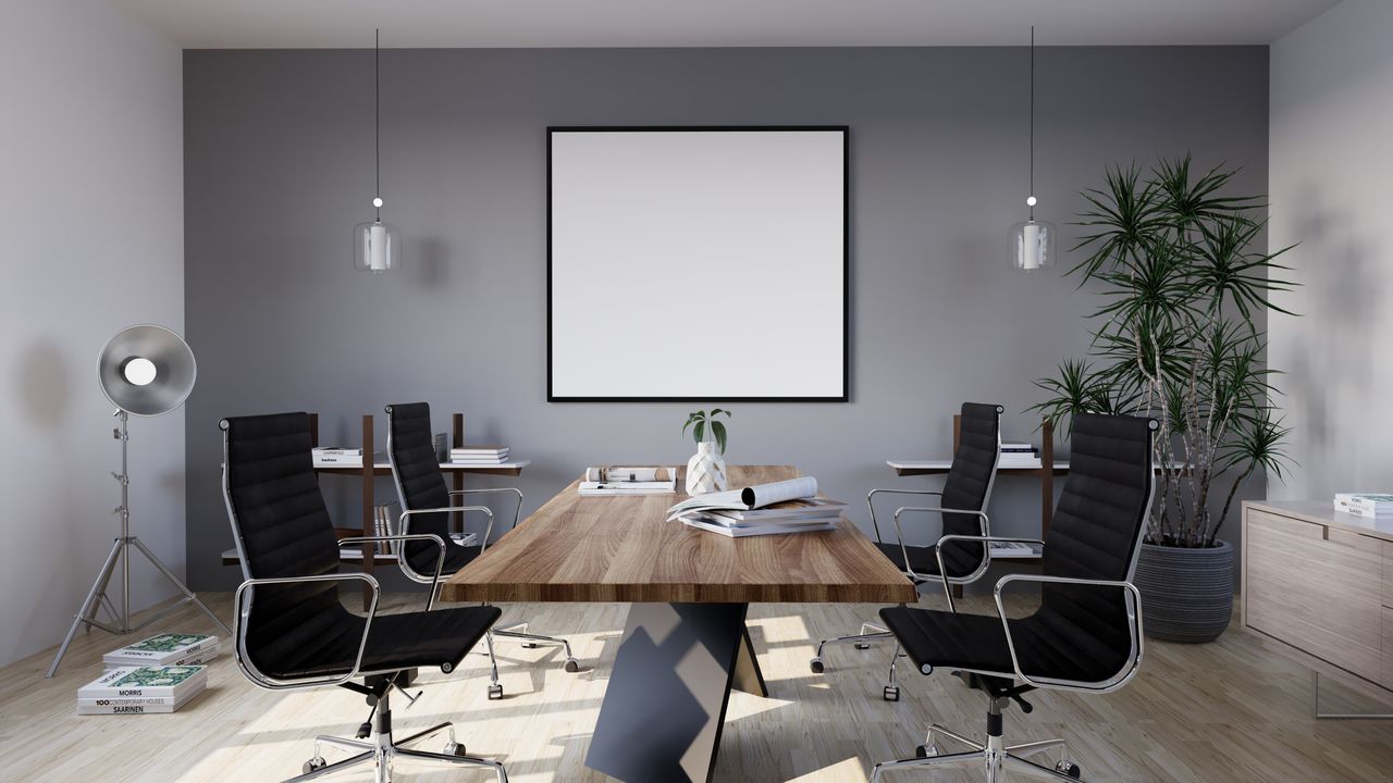 portfolio-02 Sleek and modern conference room with minimalist design featuring stylish furniture and indoor plants.